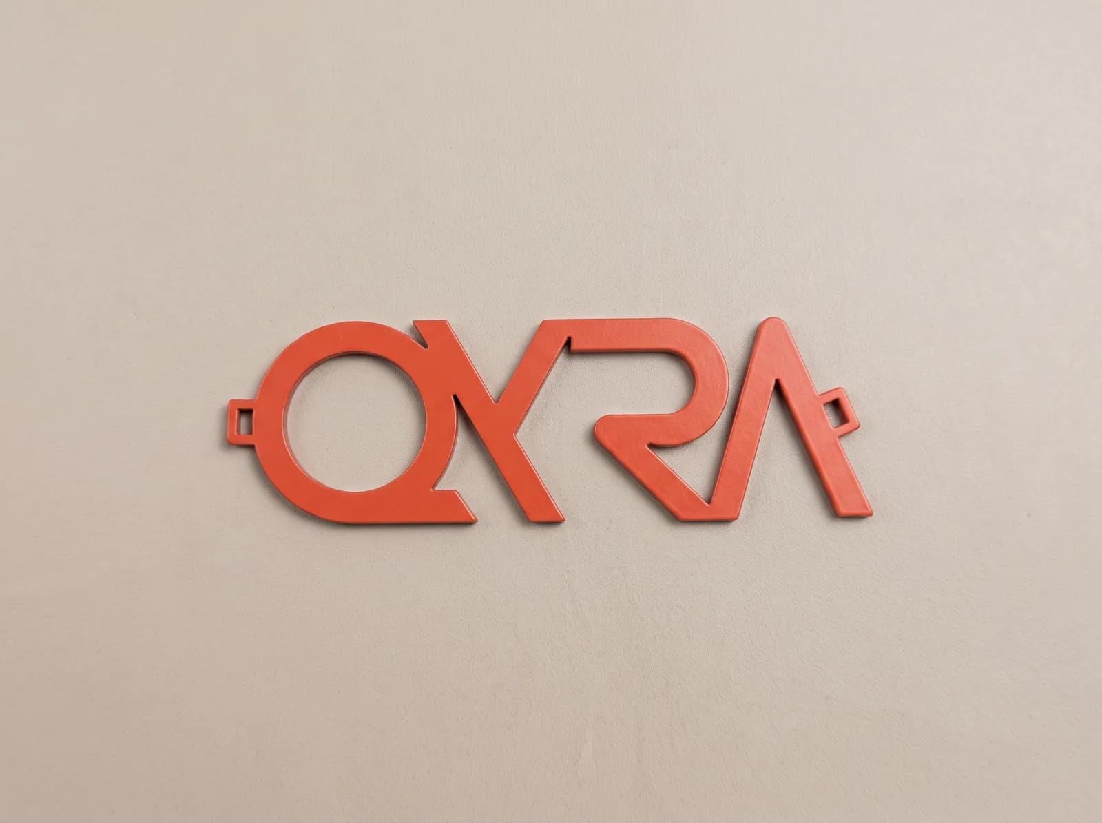Red metal logo cut to the shape of the lettering