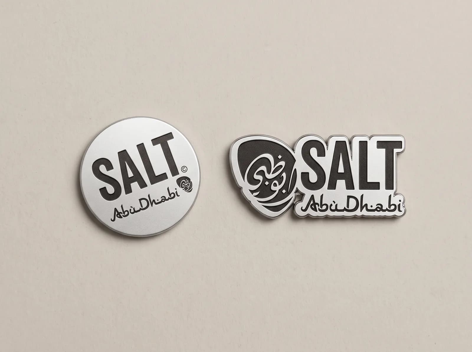 Round and logo-shaped badges made for the same restaurant brand