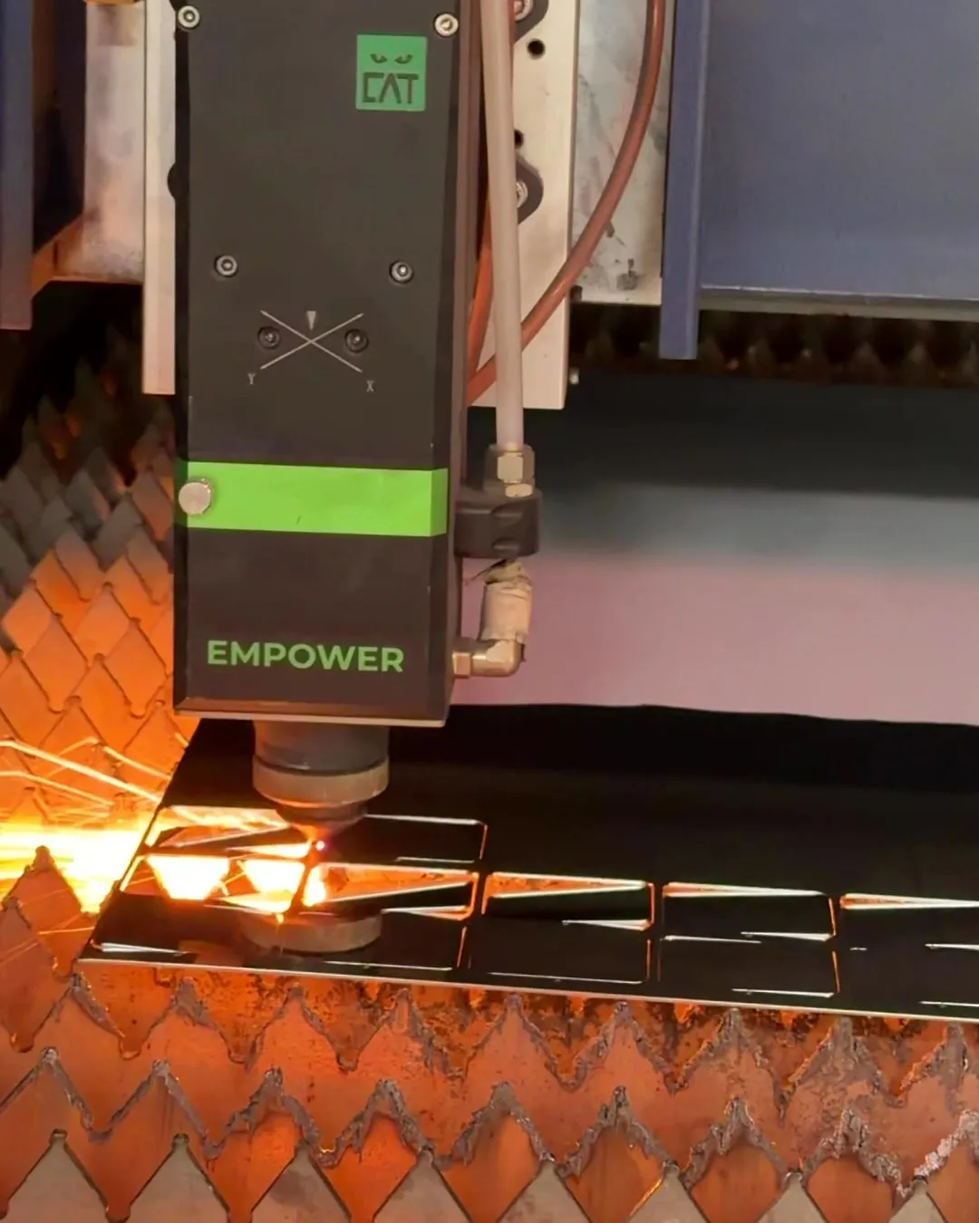 Our fibre laser cutting shapes out of a steel sheet in the Al Qusais workshop