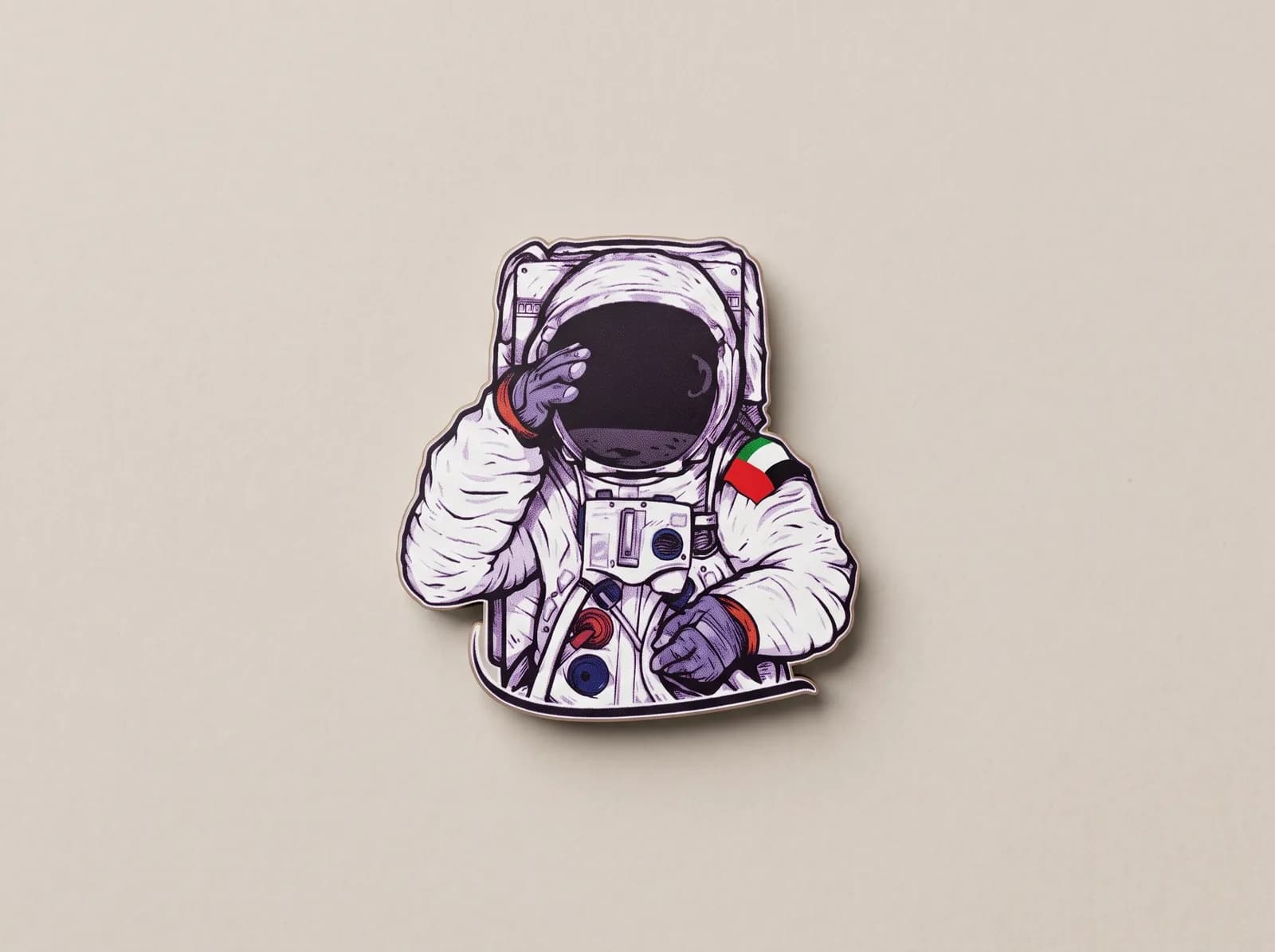 Full-colour printed metal pin of an astronaut with a UAE flag patch