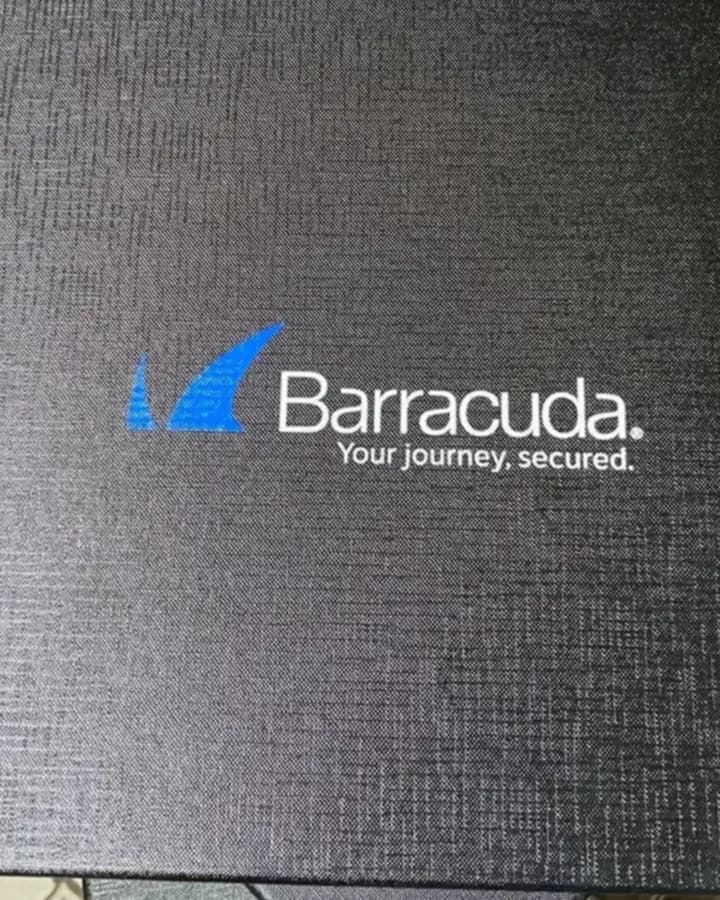 Black textured gift box lid UV printed with the Barracuda logo in blue and white