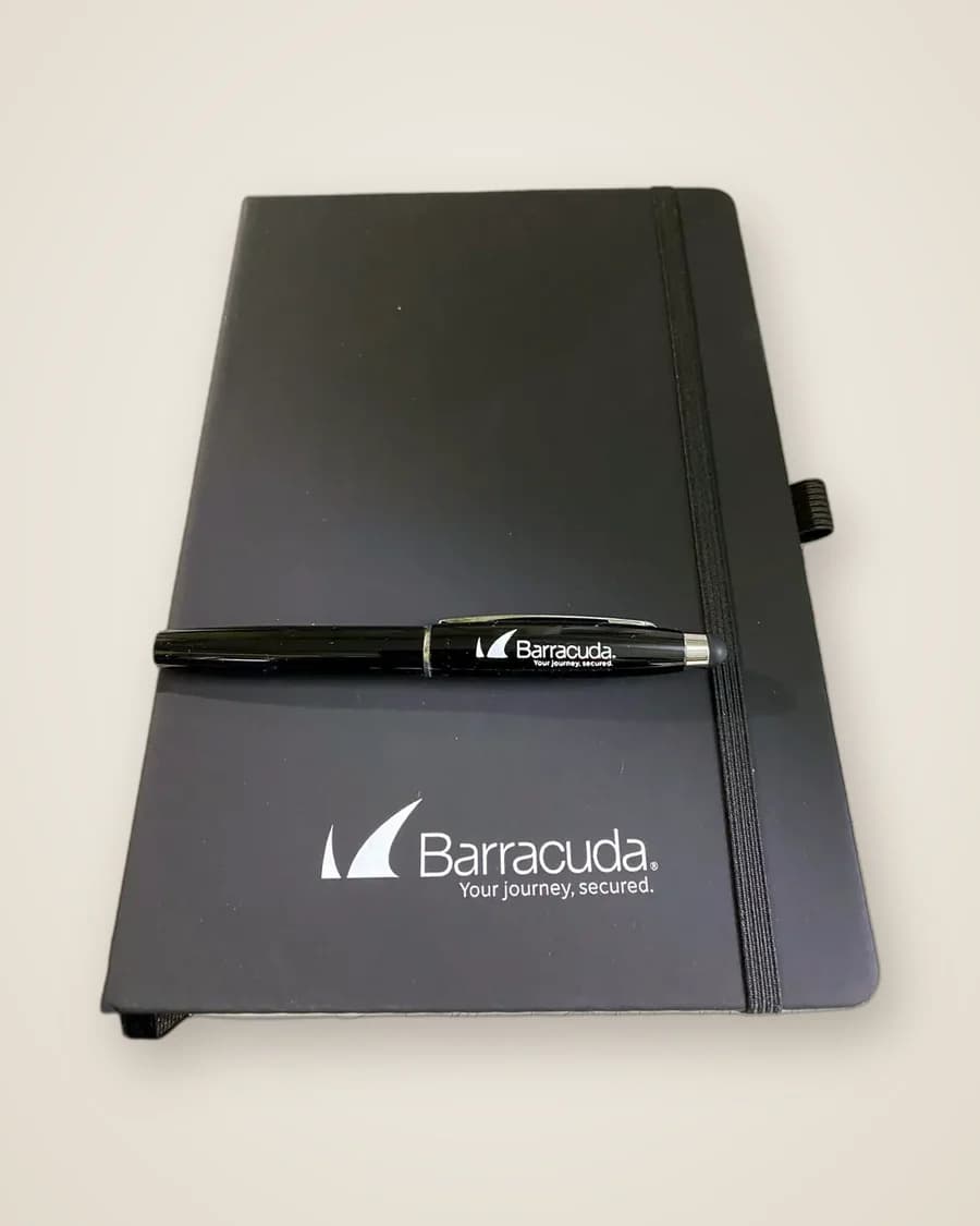 Black notebook and pen UV printed with the Barracuda logo