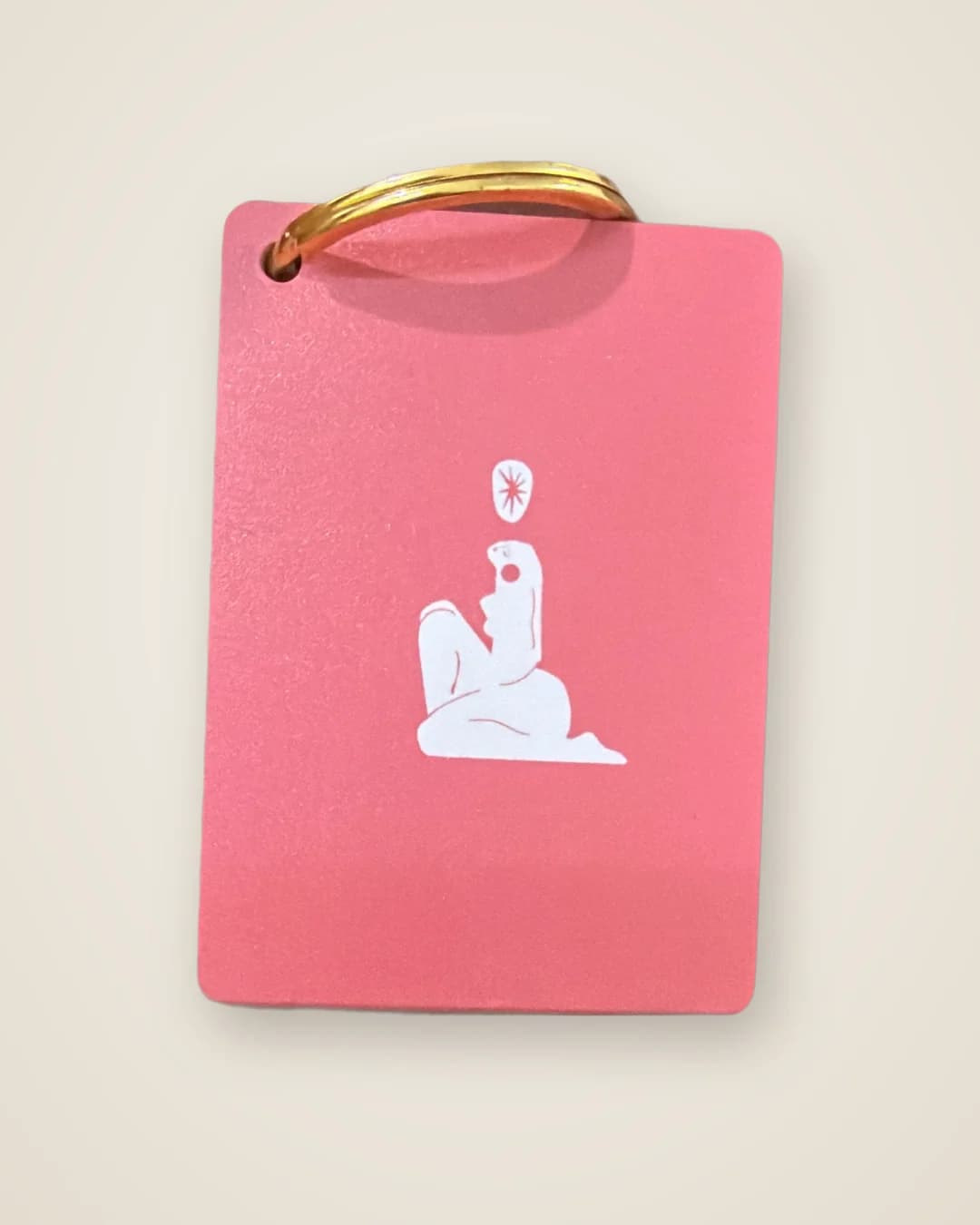 Pink steel keychain with a gold ring, UV printed with a white illustration