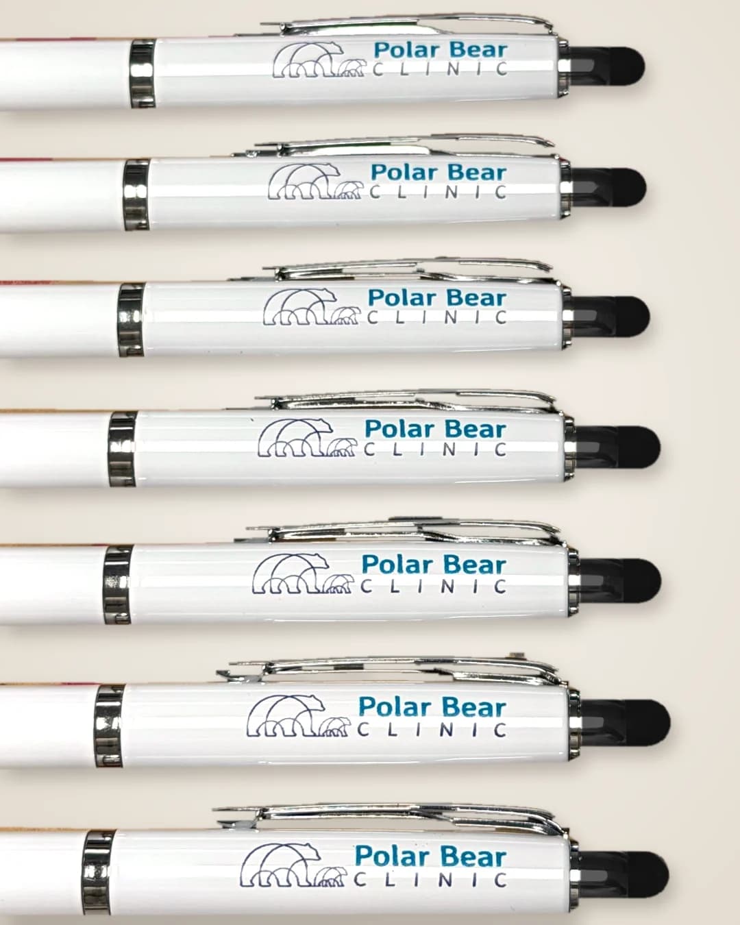 White pens with chrome clips, UV printed with the Polar Bear Clinic logo