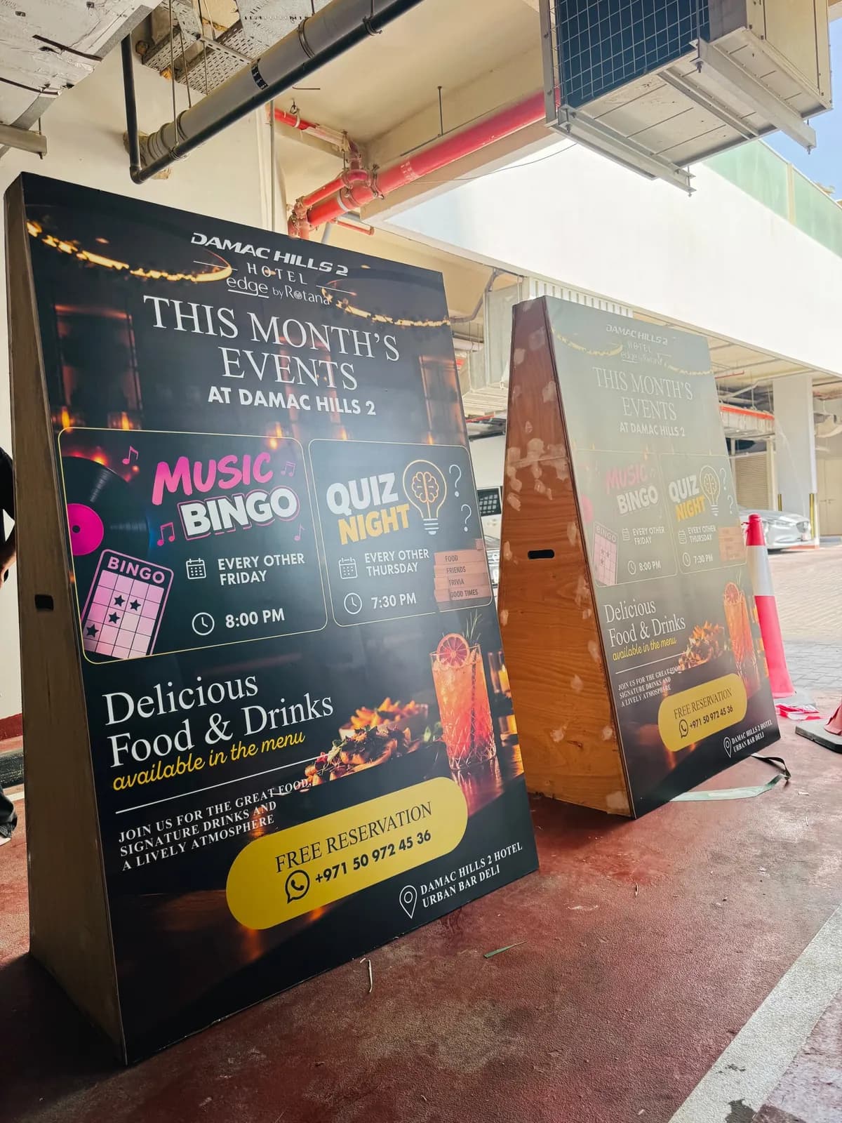 Two A-frame event boards for DAMAC Hills 2 Hotel advertising Music Bingo and Quiz Night at Urban Bar Deli