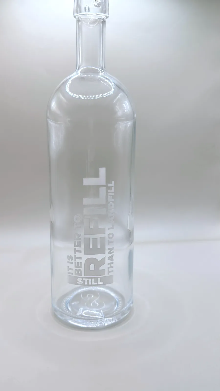 Sprudel glass water bottle printed with a message about refilling instead of landfill